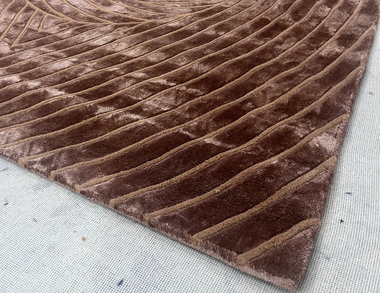 A hand-carved spiral rug corner, folded back to show the weave