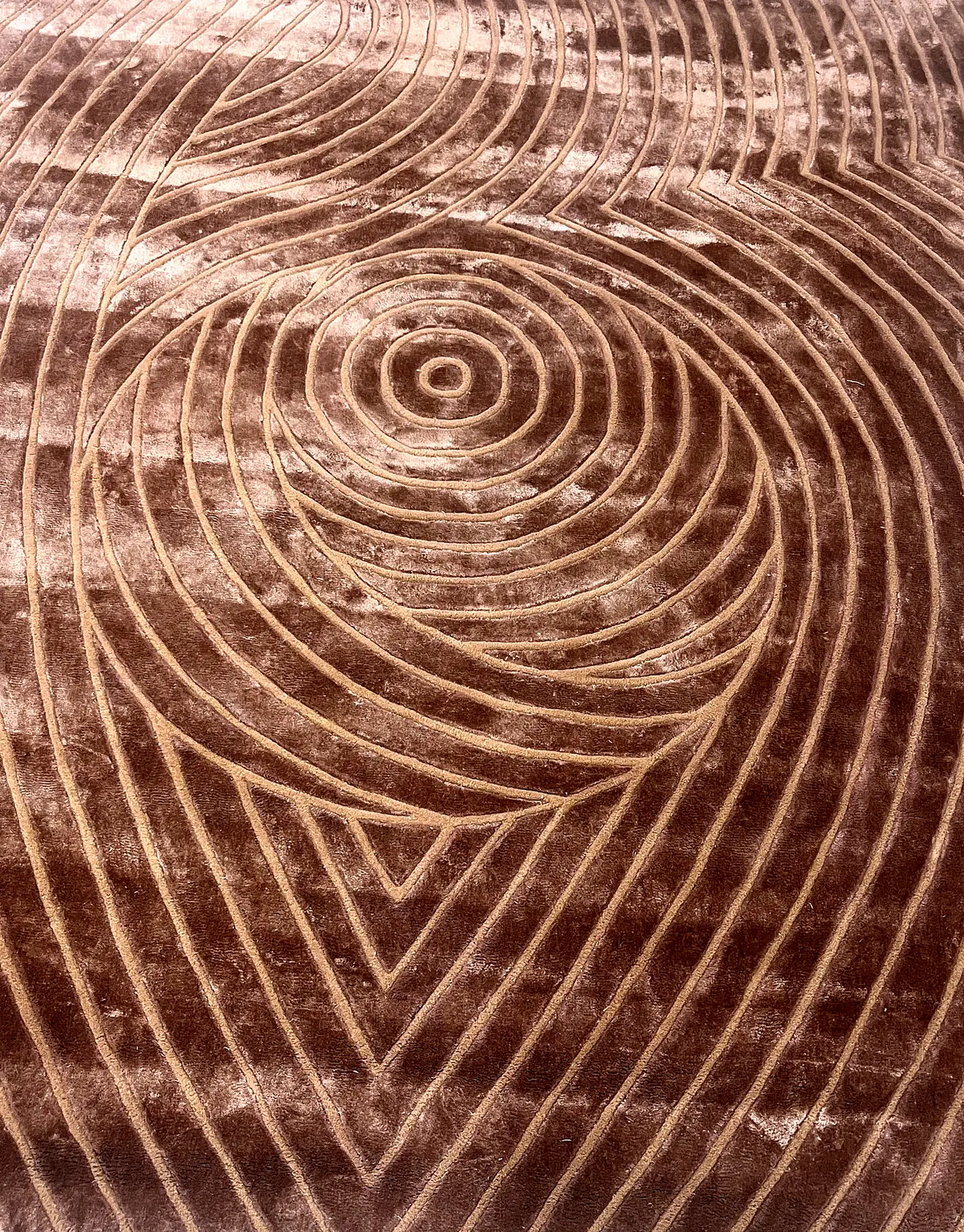 Close-up surface texture of a hand-carved spiral wool rug